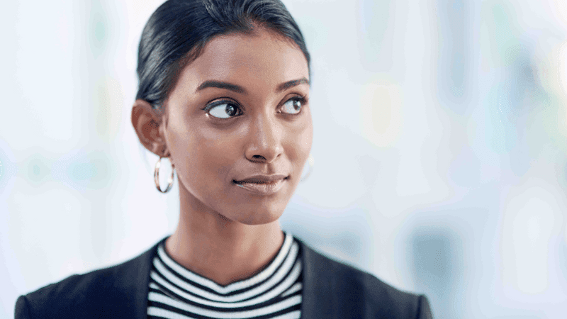 She can spot opportunity from afar. Shot of an attractive young businesswoman looking thoughtful and confident inside her office at work.