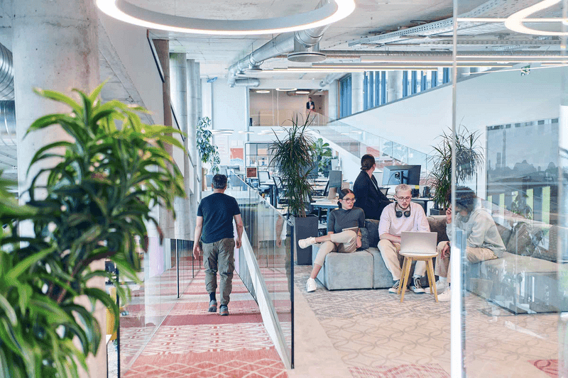 In a modern startup office, a diverse group of young professionals collaboratively tackles various business problems and challenges, surrounded by their engaged colleagues, fostering innovation and