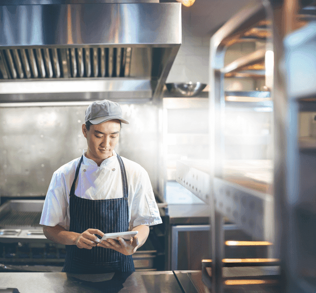 Chef using digital tablet in the commercial kitchen