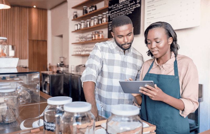 Two young African entrepreneurs working at their cafe counter