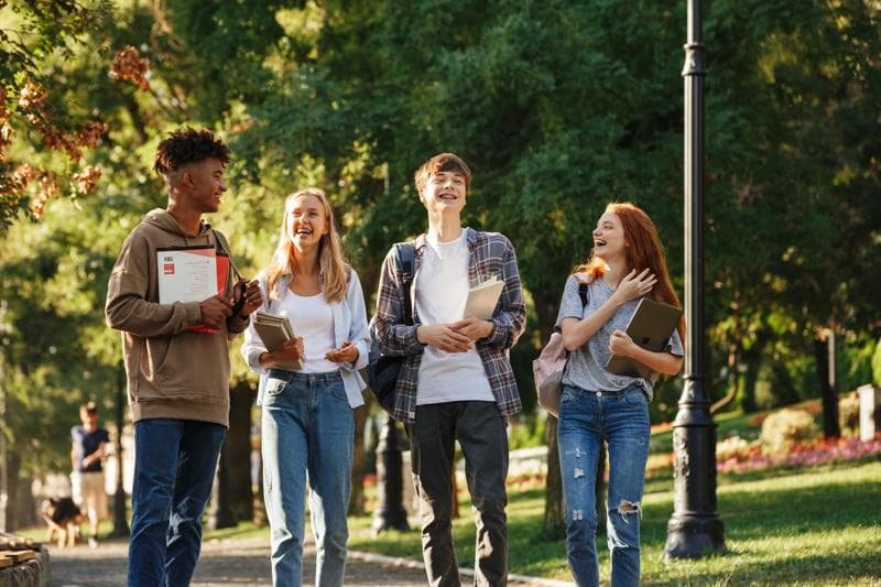 Group of happy student walking