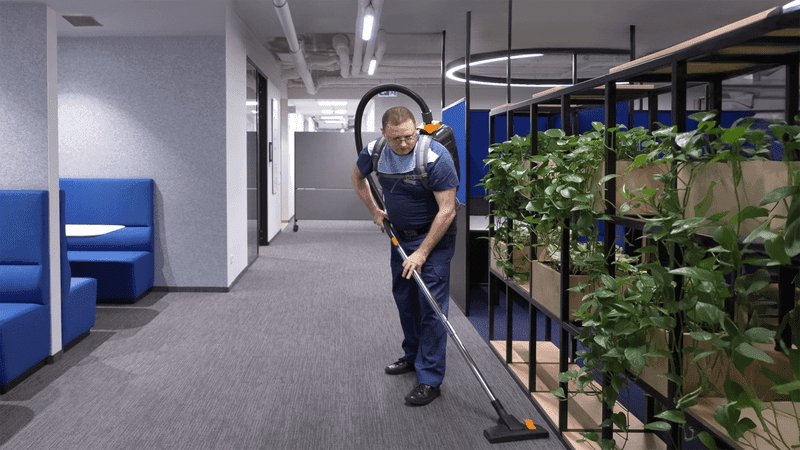 Man with backpack vacuum cleaner incl plants