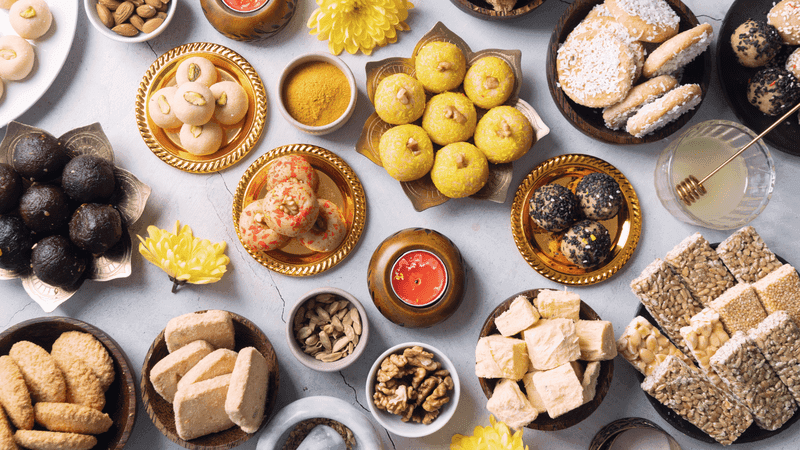 traditional indian sweets on concrete background flat lay